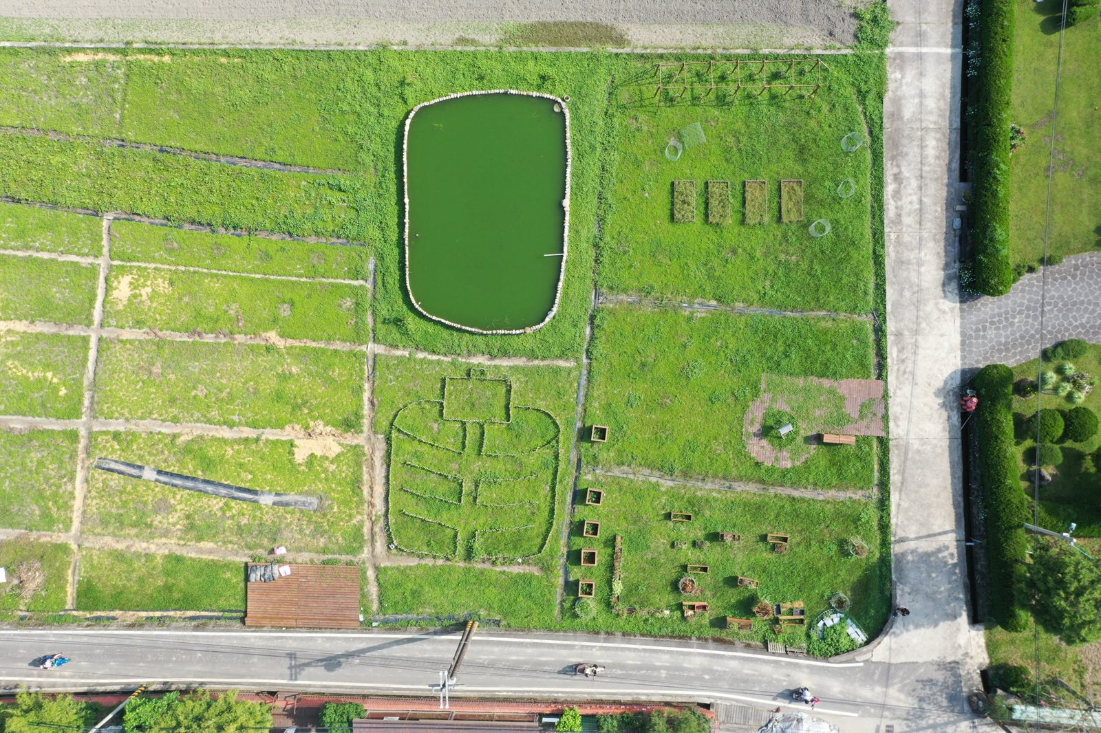 Aerial view of a social farm's fields and water reservoir